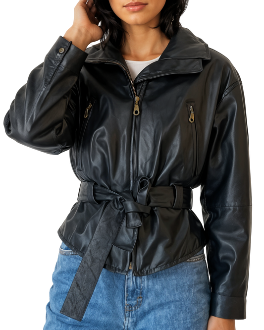 Person wearing a black leather jacket with a belt, standing against a plain background