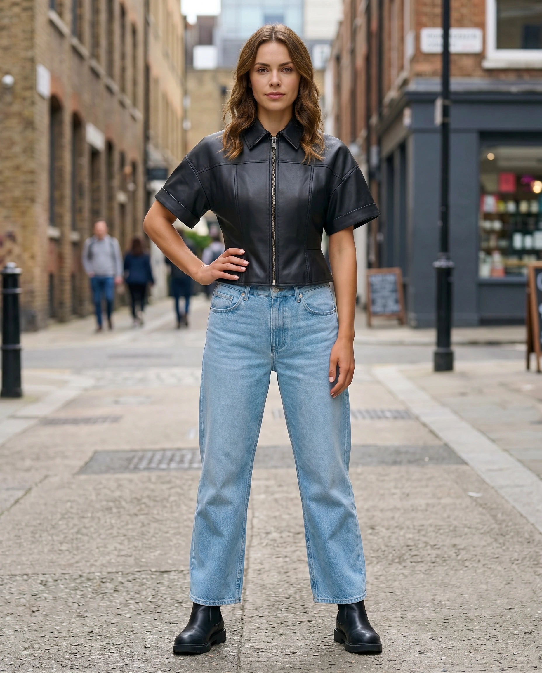 Full-length view of The Ayla women's black genuine lambskin short sleeve leather jacket by Amrika Leather styled with a casual outfit.