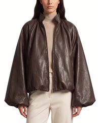 Front view of The Eira women's brown real lambskin oversized balloon-sleeve leather jacket by Amrika Leather featuring a high collar and voluminous sleeves.