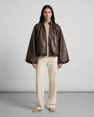 Full-length view of The Eira women's brown genuine lambskin oversized balloon-sleeve leather jacket by Amrika Leather showcasing its complete oversized silhouette and styling.