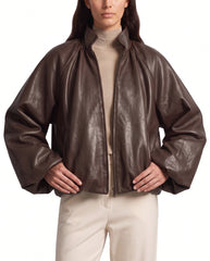 Hero pose of The Eira women's brown real lambskin oversized balloon-sleeve leather jacket by Amrika Leather styled in a contemporary fashion look.