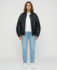 Full-length view of The Sora women's black genuine lambskin oversized bomber leather jacket by Amrika Leather styled with a casual outfit.