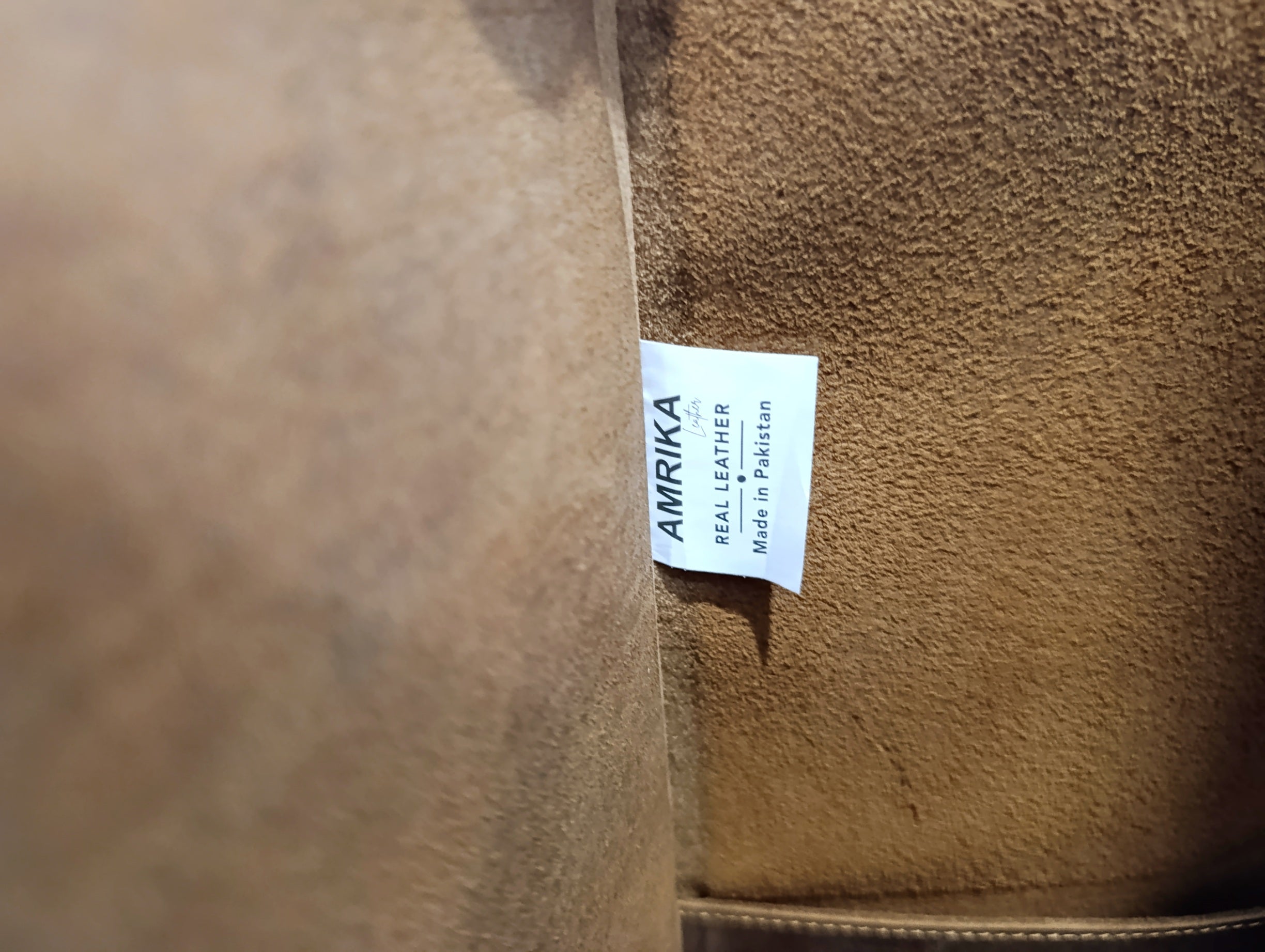 Amrika Leather brand label inside The Grand large buffalo leather tote bag.