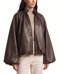 Side view of The Eira women's brown genuine lambskin oversized balloon-sleeve leather jacket by Amrika Leather showcasing its relaxed silhouette and voluminous sleeves.