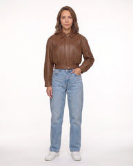 Full-length view of The Elowen women's brown genuine lambskin cropped leather jacket showcasing its complete silhouette and modern styling.