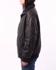 Side view of The Juno women's washed lambskin leather bomber jacket showcasing its relaxed fit and vintage-inspired washed leather finish.