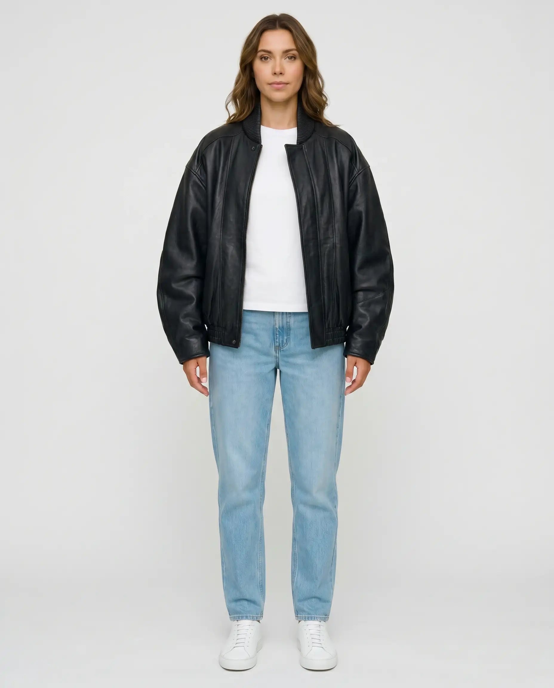 Full-length view of The Sora women's black genuine lambskin oversized bomber leather jacket by Amrika Leather styled with a casual outfit.