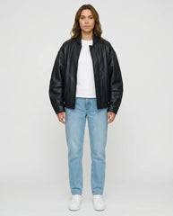 Full-length view of The Sora women's black genuine lambskin oversized bomber leather jacket by Amrika Leather styled with a casual outfit.