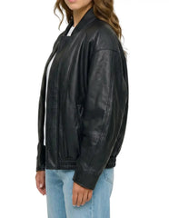 Side view of The Sora women's black real lambskin oversized bomber leather jacket by Amrika Leather showcasing the relaxed profile and rib-knit collar.