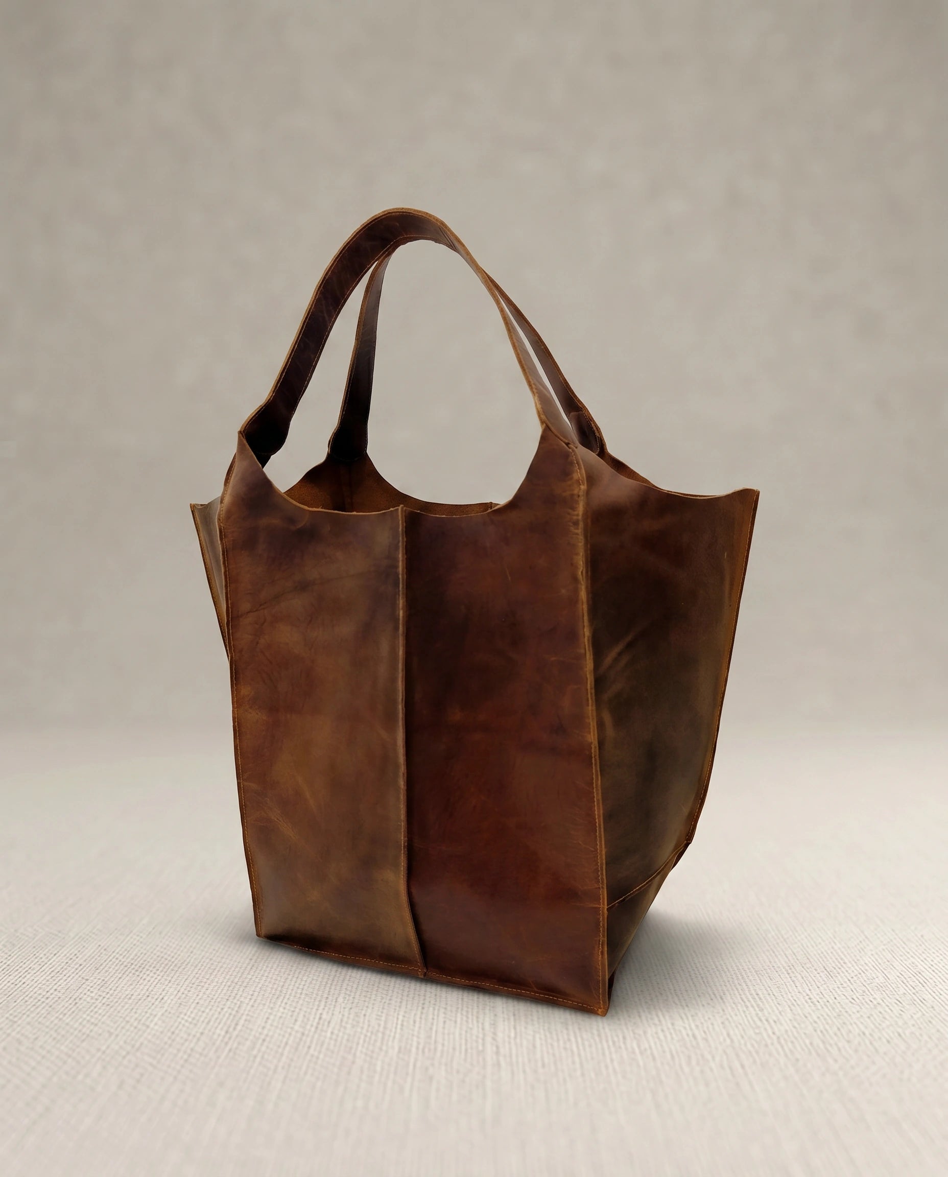 Side view of The Grand large buffalo leather tote bag by Amrika Leather in vintage pull-up leather.