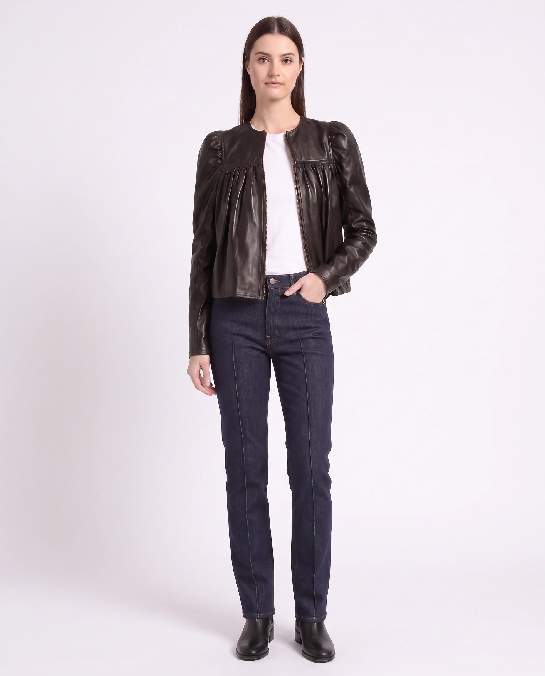 Full-length view of The Maeve women's dark brown gathered lambskin leather jacket paired with denim