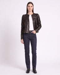 Full-length view of The Maeve women's dark brown gathered lambskin leather jacket paired with denim